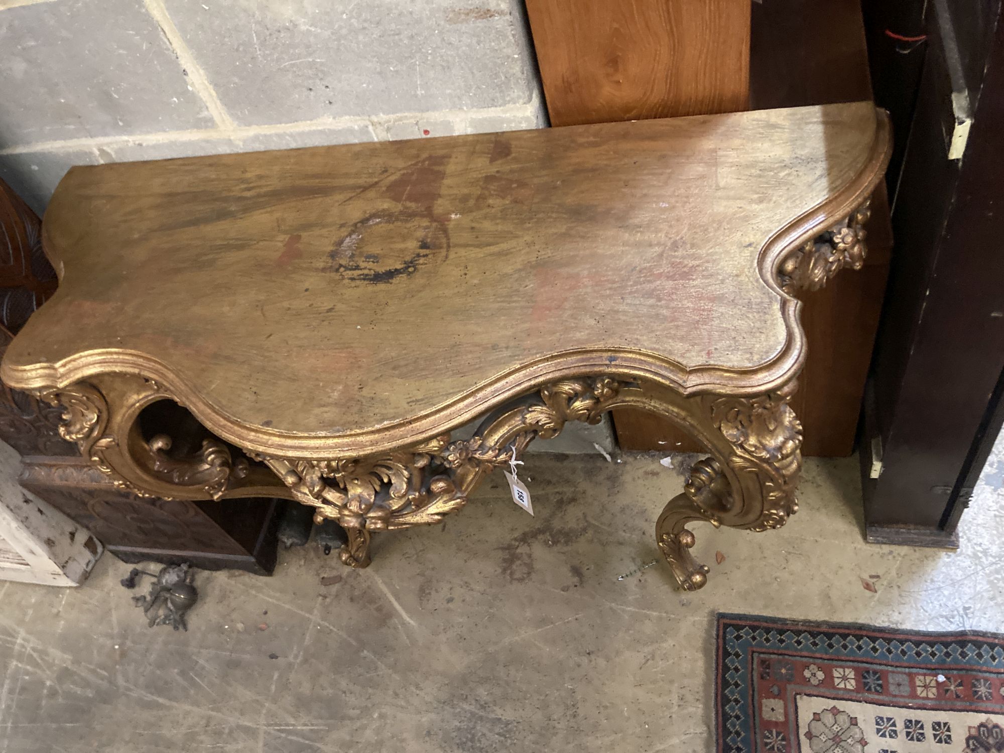 A Louis XV style carved giltwood serpentine console table, width 120cm, depth 50cm, height 89cm